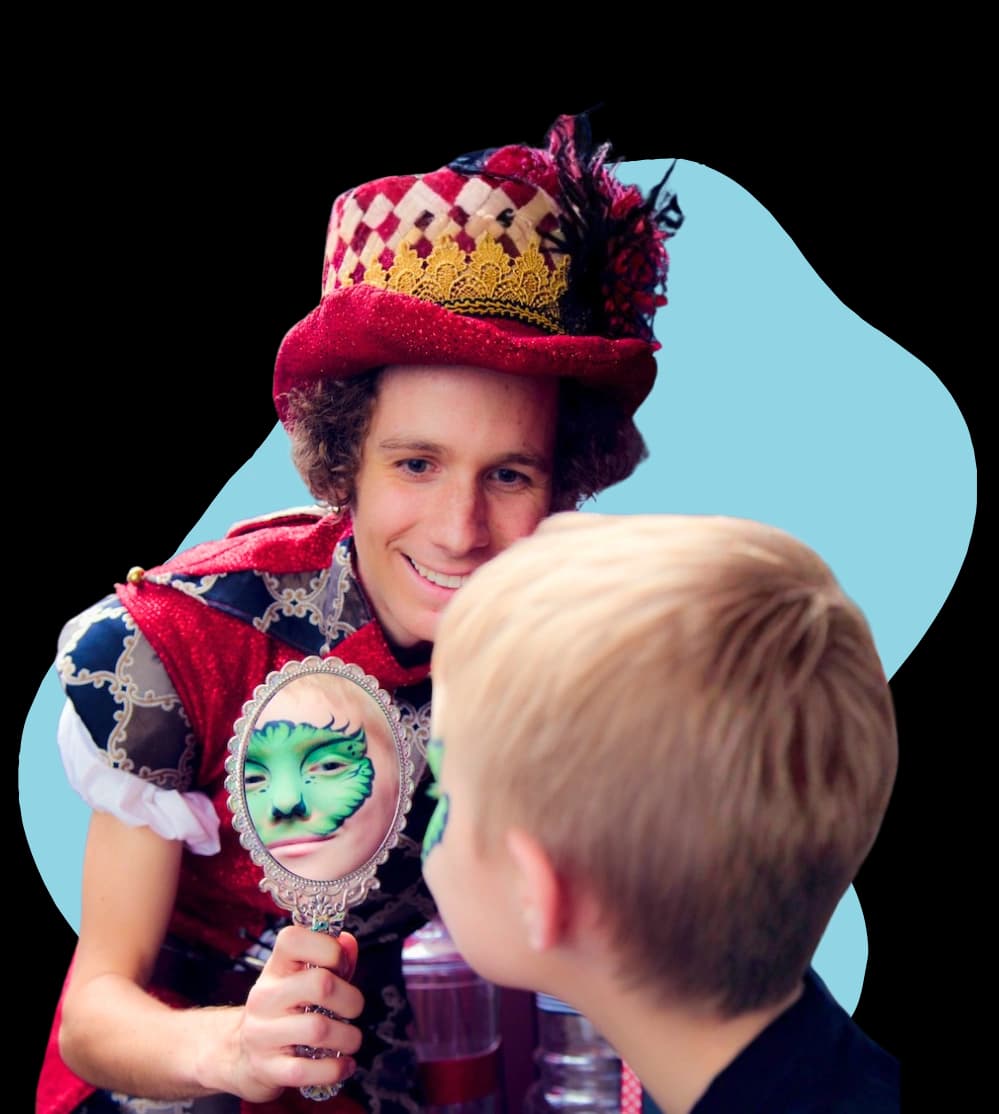 A Happily Ever Laughter faerie in costume playing face-painting with a child