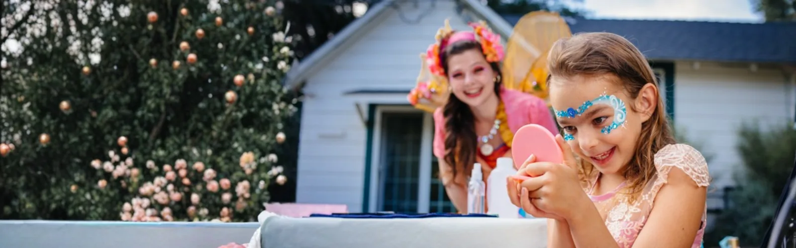 A Happily Ever Laughter face painter transforming a child into a colorful character.