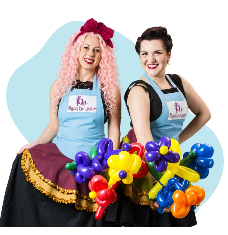 A Happily Ever Laughter balloon twister handing a freshly made balloon animal to a delighted child.