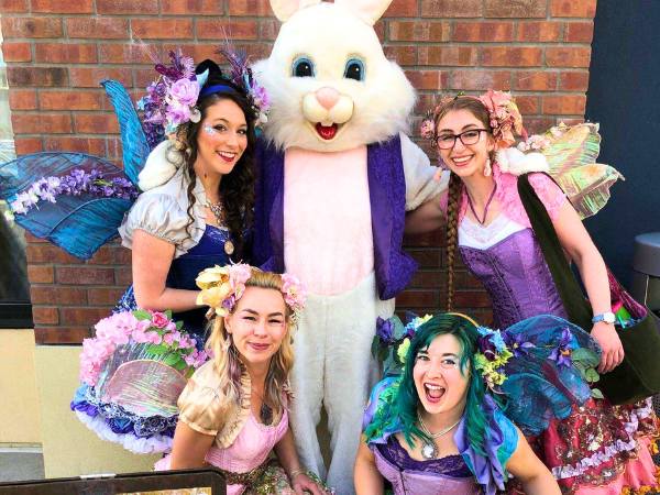 Happily Ever Laughter performers dressed as whimsical fairies posing with the Easter Bunny, perfect for holiday-themed kids' entertainment and events in California.