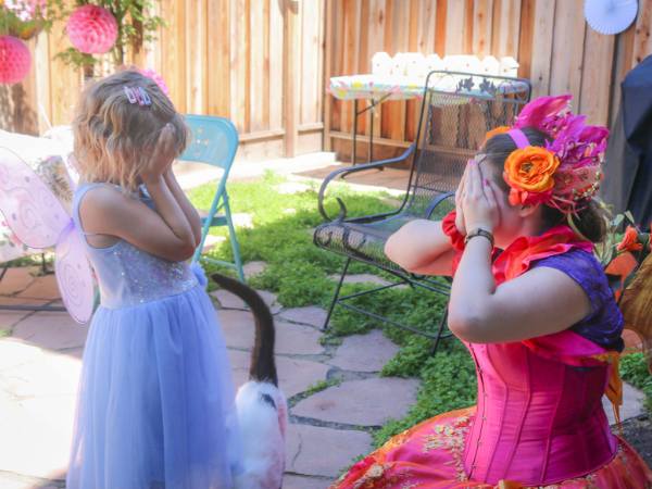 Fairy performer from Happily Ever Laughter playing a fun hide-and-seek game with a young child at an outdoor easter party, showcasing personalized and engaging easter entertainment for children’s events in California.