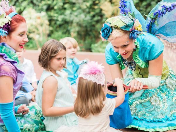 Happily Ever Laughter entertainers engaging children in magical activities, including surprise-filled props, perfect for an Easter-themed event at a country club.