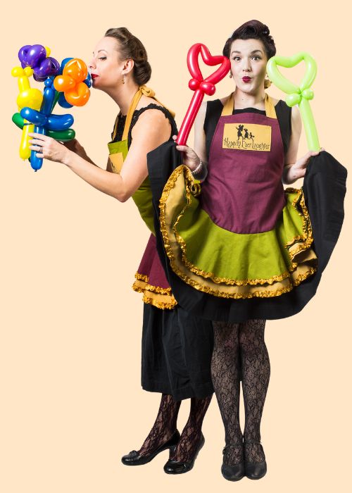 Two Happily Ever Laughter entertainers dressed in charming outfits holding colorful balloon creations, ready to bring fun and creativity to children's parties and special events in California.