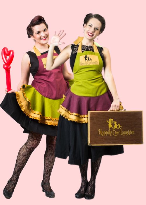 Two Happily Ever Laughter entertainers dressed in charming outfits holding colorful balloon creations, ready to bring fun and creativity to children's parties and special events in California.